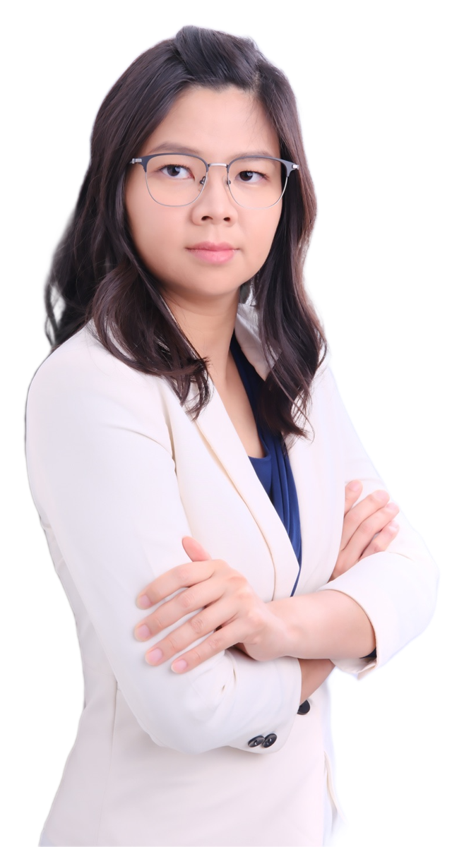 Jia Lin Cheoh standing with arms crossed, wearing a cream blazer.